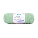 A skein of Grundl Hello Again yarn in a soft mint green color, featuring a pink and white paper label with the brand name 'grundl' and product name 'hello again'.
