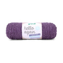 A roll of purple pet yarn with a white paper label that reads 'gründl hello again' on a clean white background.