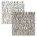 Two sheets of patterned paper arranged on a white background. Featuring a collage of city names in distressed typography, including London, York, Manchester, and others, in shades of taupe, brown, and off-white.