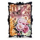 A decorative art print or card featuring a black ornate frame, pink peony flowers, a butterfly, and a warm multicolor abstract background on a white studio backdrop.