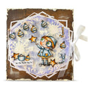 A square handmade Christmas ornament or decorative card featuring a whimsical illustrated girl in winter clothing, surrounded by ornaments, stars, candy canes, and a small snowman figure on a distressed brown and white layered background with a white ribbon tied on the right side.