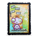 A square mixed-media art card featuring a whimsical cartoon girl with large eyes, orange hair, and a pink flower, surrounded by text boxes and decorative elements, framed by a black scalloped border on a white background.