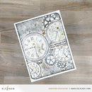 Decorative card with clock designs and text on a wooden surface, featuring the brand 'Altenew'.