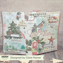 A Christmas-themed scrapbook album or journaling pad cover shown open, featuring collage-style holiday designs including a Christmas tree, bird, musical notes, vintage text, and 'Merry Christmas' script. The product is photographed on a wood surface against a neutral wall, with a banner at the bottom reading 'Designed by Claire Hamer' and the brand 'ARDEN' visible.