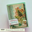 A handmade layered Christmas greeting card featuring vintage-style artwork, a striped mint green background, a small illustrated tree, a postage stamp, and a white card reading 'Christmas Greetings.' The card is photographed on a light neutral background with an Arden Creative Studio card and a designer credit banner visible.