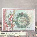 Christmas-themed card with wreath and berries on a textured surface, designed by Claire Hamer.
