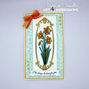 A handmade greeting card featuring orange and yellow daffodils in an ornate gold frame, with a white banner reading 'I'll always be here for you.' The card is decorated with a mint green damask pattern border, a gold inner border, and an orange ribbon bow at the top left.