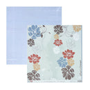 A sheet of scrapbook paper from BTDT Designs featuring a floral pattern in muted blue, red, brown, beige, and white on a pale mint background, with a second backing sheet in light blue behind it.
