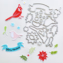 A flat lay of Christmas-themed die-cut stickers and metal cutting templates on a white background. The set includes red and pink birds, snowflakes, green leaves, a red poinsettia, a blue 'Merry Christmas' banner, and a large silver metal cutting plate with holiday shapes.
