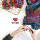Multicolored yarn with a skein and a knitted fabric, Red Heart brand visible, on a white background.