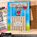 Card with a mouse holding a heart and text 'Kissing Booth 52' with craft supplies in the background.