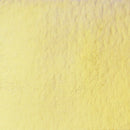 A close-up textured swatch of pale yellow material, resembling a fabric or plaster surface.