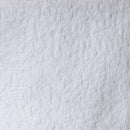 A close-up texture shot of a white, plush, and heavily textured fabric, likely a bouclé or sherpa material.