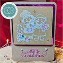 A handmade Christmas greeting card with a kraft paper base, featuring an embossed panel of two children and candy canes, with the text 'WITH LOVE AT Christmas' in pink. A circular badge in the top left reads 'Official Design Team Member 2024'.