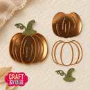 A set of autumn-themed metal craft dies shaped like a pumpkin, shown with a finished stamped pumpkin design and a green witch hat. The items are arranged on a textured beige background with a burlap fabric corner and a 'Craft & You' logo in the bottom-left corner.