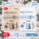 Craft & You Christmas stamp set showing the clear stamp packaging on the left and a sample stamped sheet on the right, decorated with pine branches, snowflakes, and holiday text on a white wood background.