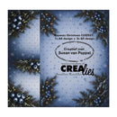 A square product card or packaging panel for a Christmas-themed paper design. The design shows a snowy blue background with pine branches, blue berries, and small warm lights, plus printed text including 'Paperzz Christmas CLRZ027', 'Creatief met Susan van Poppel', 'www.