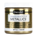 A jar of DecoArt AmericanaDECOR METALLICS bright metallic paint in a gold shade, with a white cap and white label background.