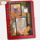 A red spiral-bound scrapbook journal or planner cover decorated with autumn-themed collage elements, including two photo inserts, orange and brown paper leaves, textured black paper, and fall-colored labels. The journal is photographed on a light neutral background with a small Elizabeth craft designs logo in the top-left corner.