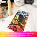 Artistic gel plate with bird design on a surface with GELEF acrylic mediums and tools.