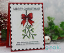 A handmade Christmas greeting card with a red border, black scalloped inner border, and a central mistletoe illustration with a red bow. The card reads “MERRY CHRISTMAS” at the top and “May God’s love and blessings shine on you this holiday season.