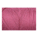 A close-up of pink yarn wound into a skein, showing the twisted plies and soft texture against a plain white background.