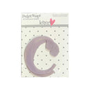 A lavender plastic letter 'C' die-cut sticker from Pocket Scaps by Heidi Grace Designs, presented on its original white card backing with a gray polka dot pattern.