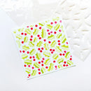 A square card featuring a repeating watercolor holly and berry pattern in red, light green, and lime green on a white background, styled with white stencils on a white surface.