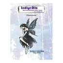IndigeBlu 'Glamorous' fairy rubber stamp packaging, featuring a black ink sketch of a fairy with dark wings on a distressed light blue and white background.