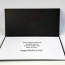 A black and white pop-up greeting card shown open, with a black back panel and a white front panel printed with the message, 'There's nothing better than spending this day with the person I care about the most.