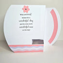 Greeting card with pink flower and text on a white background