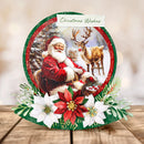Christmas-themed card with Santa Claus and reindeer, surrounded by flowers on a wooden surface.
