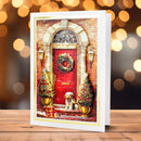 Christmas card with a red door, wreath, and dog in front of a blurred light background