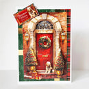 A Christmas greeting card featuring a festive front door scene with a red door, wreath, lit lanterns, decorated trees, and a small dog sitting at the door. A small card in the top left reads 'Christmas Wishes from Lulu's'.