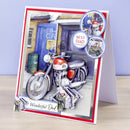 A handmade greeting card for Dad, featuring an illustration of a red and silver motorcycle parked in front of a garage. The card has red and white borders, circular embellishments, and the text 'BEST DAD' and 'Wonderful Dad'.