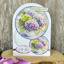 Greeting card with hydrangea design and 'In Our Thoughts' text on a wooden surface.