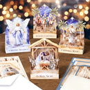 Collection of Christmas cards featuring nativity scenes and angel figures on a wooden surface with blurred lights in the background.