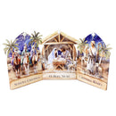 A three-panel nativity scene tabletop decoration on a white background. The center panel shows the Holy Family in a stable with the text 'O Holy Night,' while the left panel depicts three wise men with camels and the text 'Seasons Greetings,' and the right panel shows the Magi with sheep and the text 'Christmas Wishes.