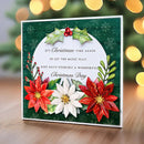 Christmas card with floral design and festive text on a blurred background