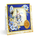 A handmade Christmas nutcracker card featuring a blue and gold nutcracker figure, blue and gold poinsettia flowers, and elegant gold foil details on a dark blue and gold layered card base.