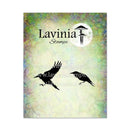 Lavinia Stamps logo card featuring a textured pastel background with green, yellow, and blue tones, black bird silhouettes, and the brand name 'Lavinia Stamps' with a moon-and-stamp icon.