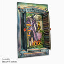 A square mixed-media art craft card or box by Tracey Dutton, featuring a whimsical illustrated witch in a purple cloak standing in a mossy forest with mushrooms, a pumpkin, and open bookshelves. The piece is photographed against a clean white background with the creator's name printed in the lower-left corner.