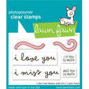 Lawn Fawn photopolymer clear stamps add-on featuring two moth-shaped clear stamp pieces, two text stamps reading 'i love you' and 'i miss you', and two small text stamps reading 'I ♥ YOU SO MOTH' and 'MISS YOU SO MOTH' on a teal and white backing card.