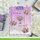 A handmade pull tab greeting card with a lavender and pink butterfly theme, surrounded by white flowers and craft ink pads. The card features cartoon butterflies, stars, and the text 'thank you very much' with a 'PULL' tab at the top.