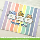A handmade greeting card with pastel rainbow vertical stripes and cute cartoon animals holding signs that read 'THX A LOTL', 'U MAKE ME CAPY', and 'THANK MEW', with 'THANK YOU!' in blue letters across the bottom. The card is photographed on a light wood surface.