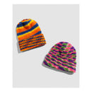 Two colorful crochet beanies on a light gray background