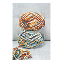 Two multicolored skeins of yarn stacked on a textured gray surface