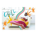 Women laying on couch with a crochet blanket over her legs. Illustrations and word chill in corner of image