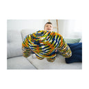 Child playing with a colorful, knitted toy on a couch