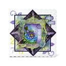 A square layered scrapbook card featuring a central diamond-shaped overlay with a blue and purple rose, vintage script, postage stamps, and decorative borders in purple, green, black, and white.